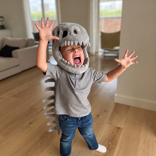 Boy roaring in the grey dinosaur skeleton costume