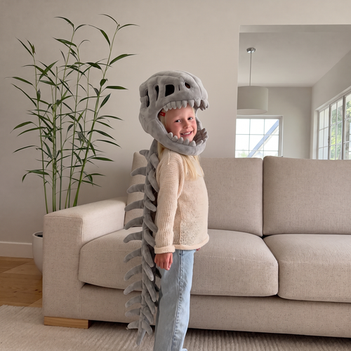 Child wearing the Bone Grey Bonesaur plush dinosaur skeleton costume