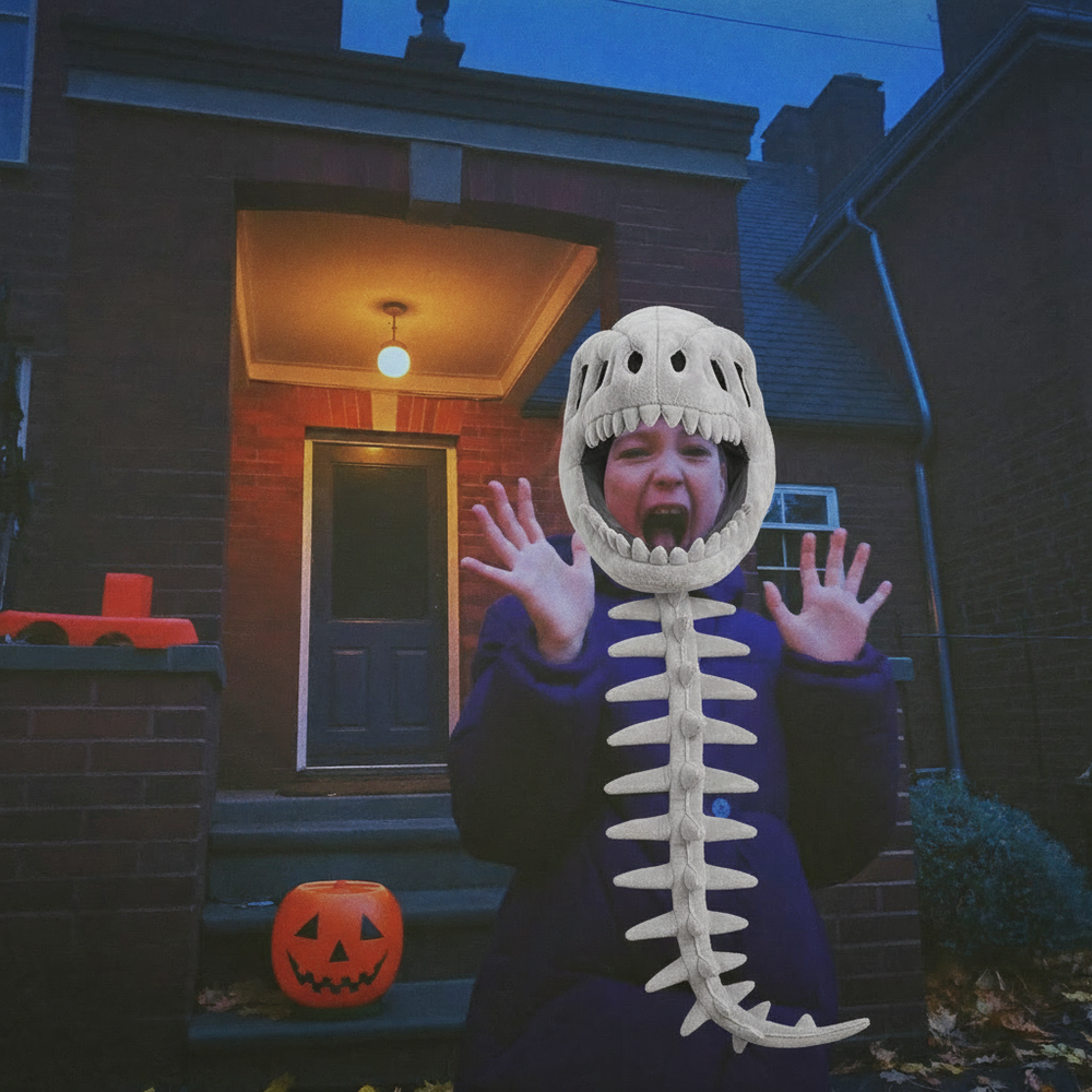 Girl in the Bonesaur costume trick or treating at a spooky house